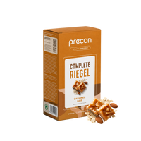 Eine Packung „Complete Riegel Caramel Bar“ von Anona GmbH als Mahlzeitenersatz, bestehend aus Karamellriegeln, Mandeln und Haferflocken, in einer braun-weißen Verpackung mit gut sichtbaren Marken- und Produktangaben.