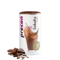 Eine Precon Schoko Shake Dose zeigt ein Glas cremigen Schokoladenshake mit einem Spritzer, daneben Schokoladenstückchen auf weißem Hintergrund - ein Hinweis auf diesen Mahlzeitenersatz zum Abnehmen.